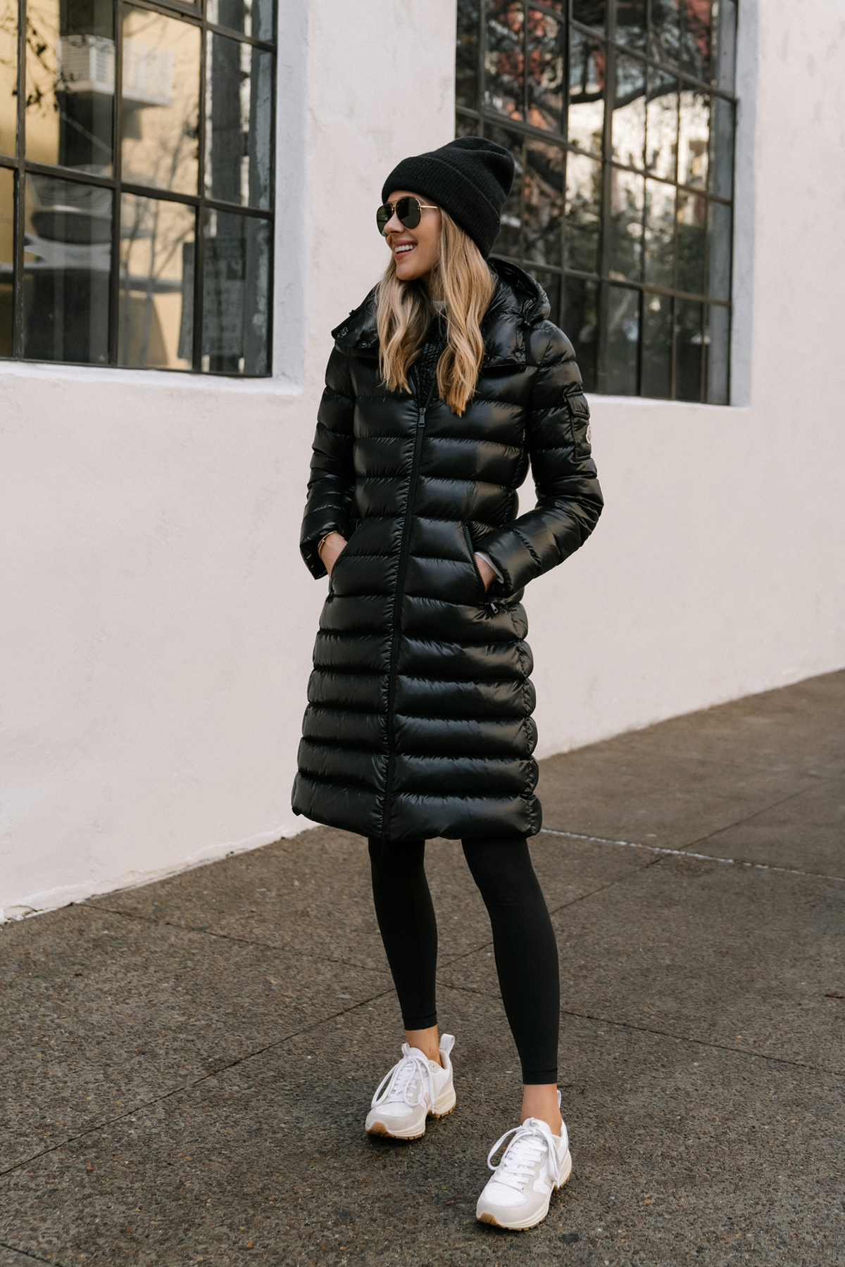 Fashion Jackson Wearing Black Moncler Moka Quilted Down Long Parka Black Leggings Veja Venturi Sneakers Black Beanie Celine Aviator Sunglasses Winter Coat Street Style 1