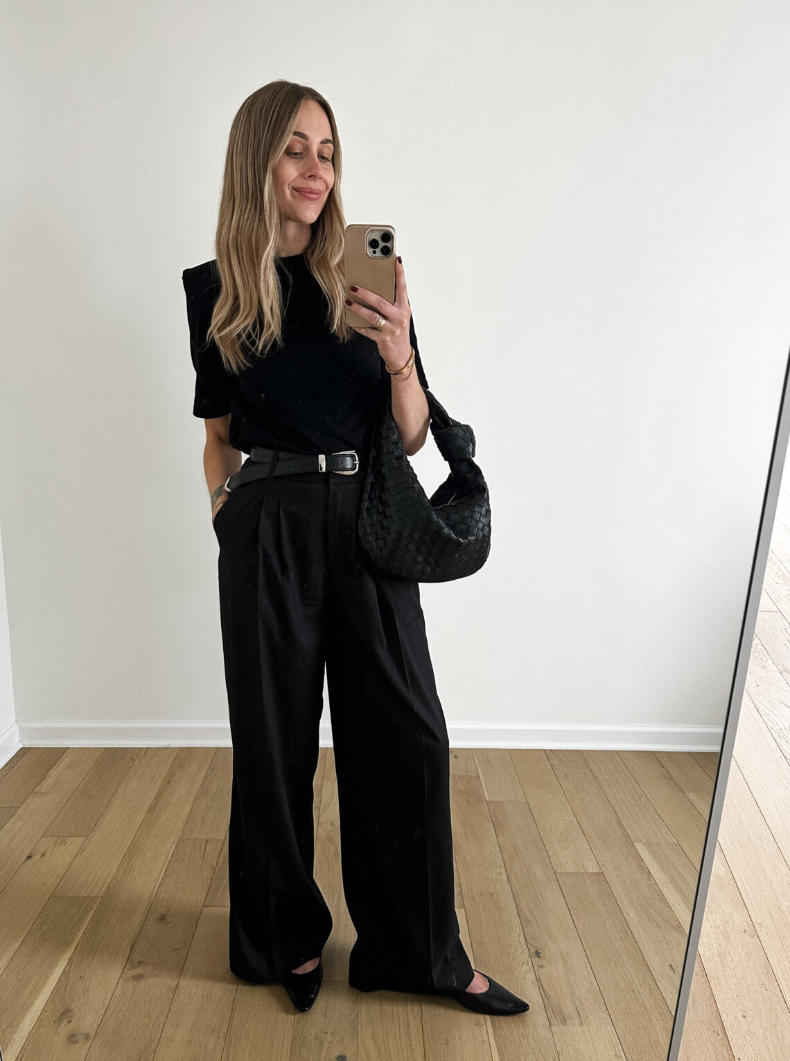 Fashion Jackson Wearing black puff sleeve tshirt MAYSON the label black wide leg trousers the row black Claudette flats, khaite black benny belt, bottega veneta black teen jodie handbag