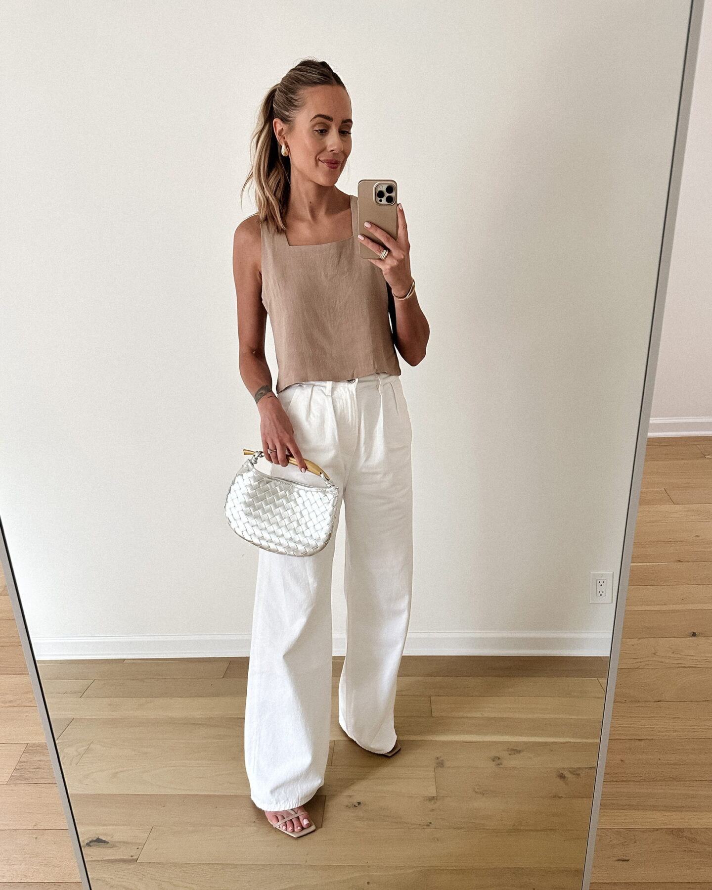 Fashion Jackson Wearing Beige Linen Tank Citizens of Humanity White Trouser Jeans Nude Sandals Metallic Silver Woven Clutch Summer Date Night Outfit