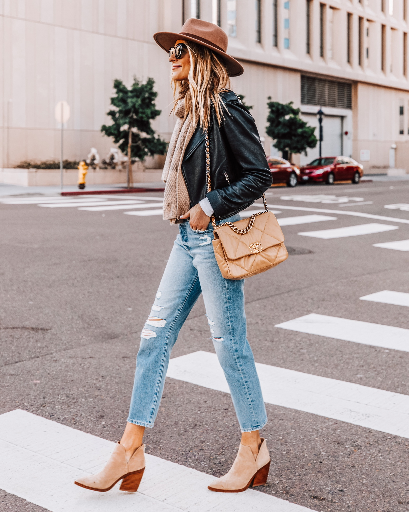 Fashion Jackson Wearing Black Leather Jacket Outfit Tan Hat Ripped Jeans Tan Scarf Tan Booties, womens leather jacket outfit,﻿﻿ ﻿madewell leather jacket outfit, ﻿﻿ ﻿casual leather jacket outfit, ﻿ ﻿﻿leather jacket and booties outfit