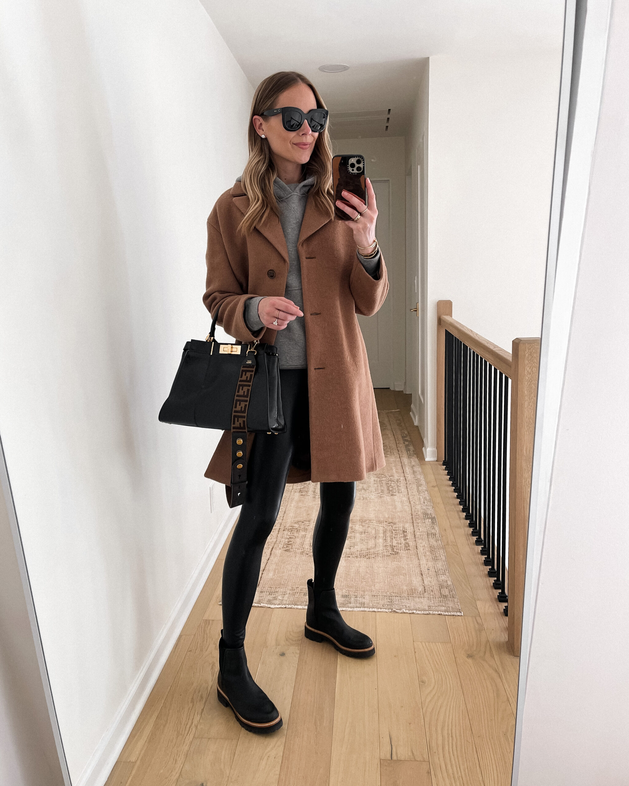 Fashion Jackson Wearing Camel Coat Grey Hoodie Sweatshirt Black Faux Leather Leggings Black Lug Sole Boots Fall Outfit