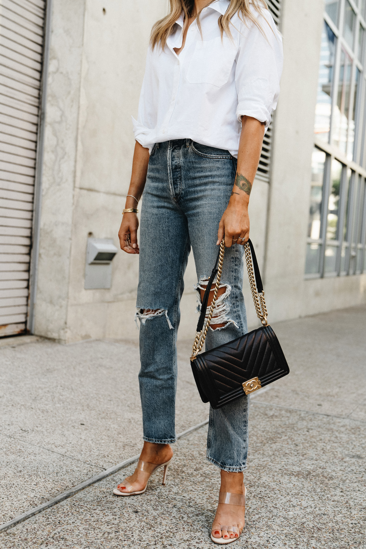 Fashion Jackson Wearing Jenni Kayne White Button Up Shirt AGOLDE Ripped Jeans Chanel Black Boy Bag Schutz Clear Heeled Sandals