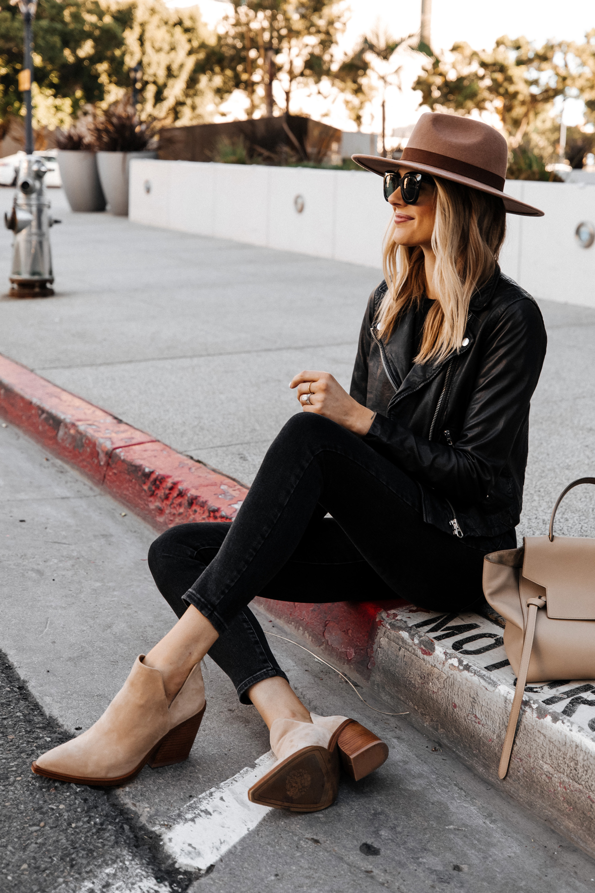 Fashion Jackson Wearing Madewell Black Leather Jacket Black Jeans Vince Camuto Gigetta Tan Suede Booties Tan Wide Brim Hat