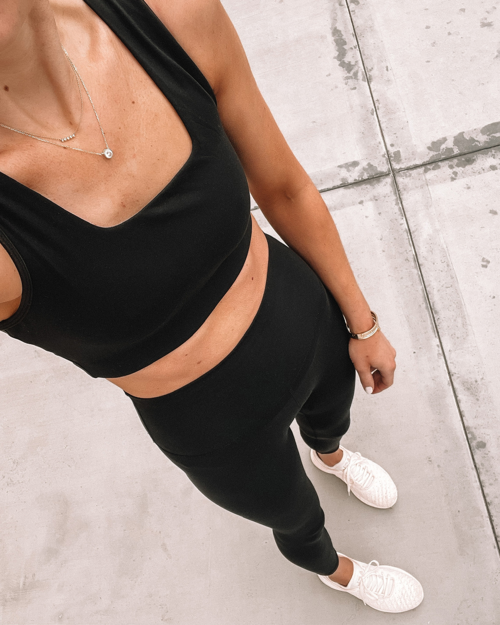 Fashion Jackson Wearing Varely Black Sports Bra Varley Black Leggings APL Sneakers workout outfits for women