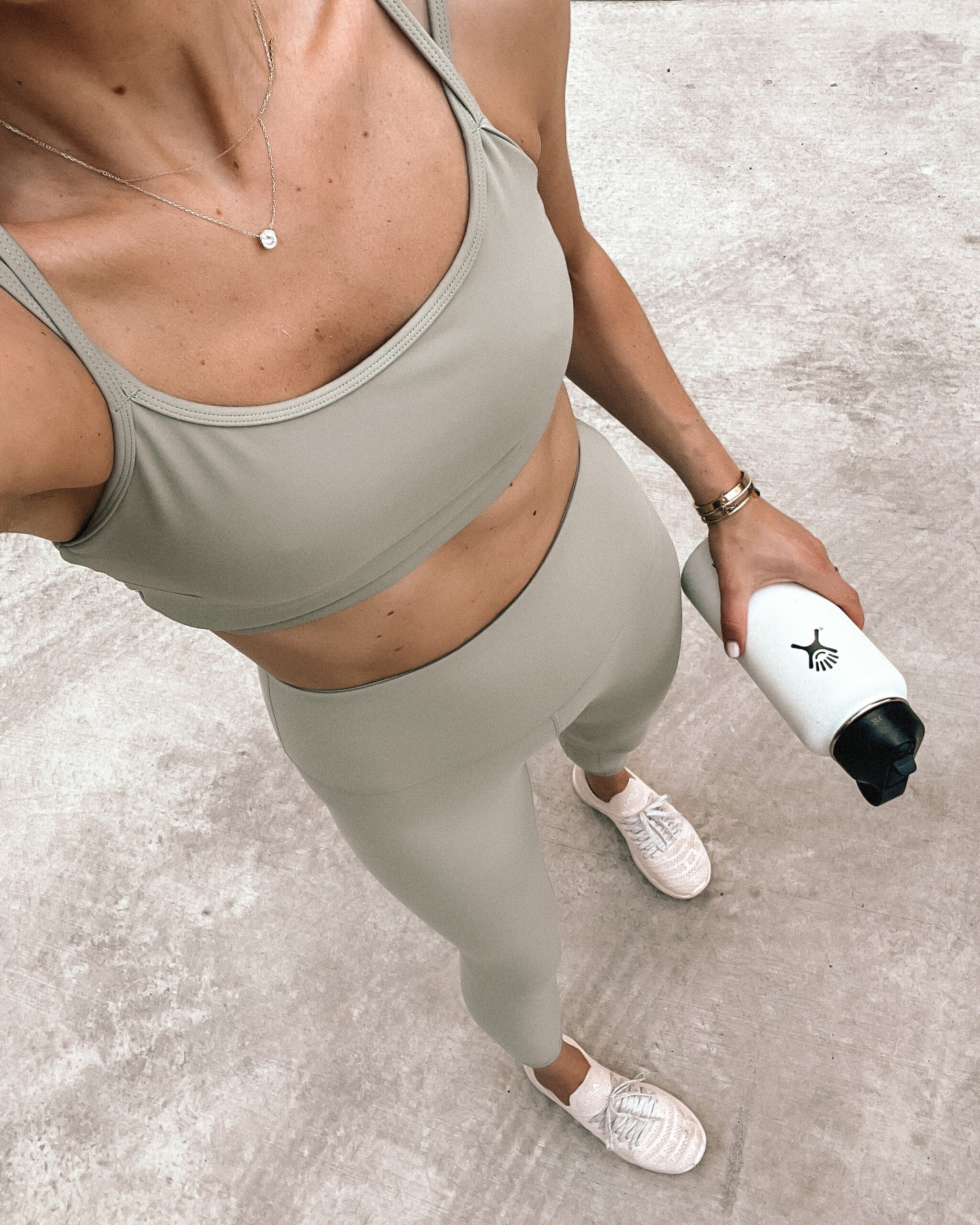 Fashion Jackson Wearing Varley Light Green Strappy Sports Bra Varley Light Green Leggings Blush APL Sneakers White Hydroflask Womens Workout Outfit