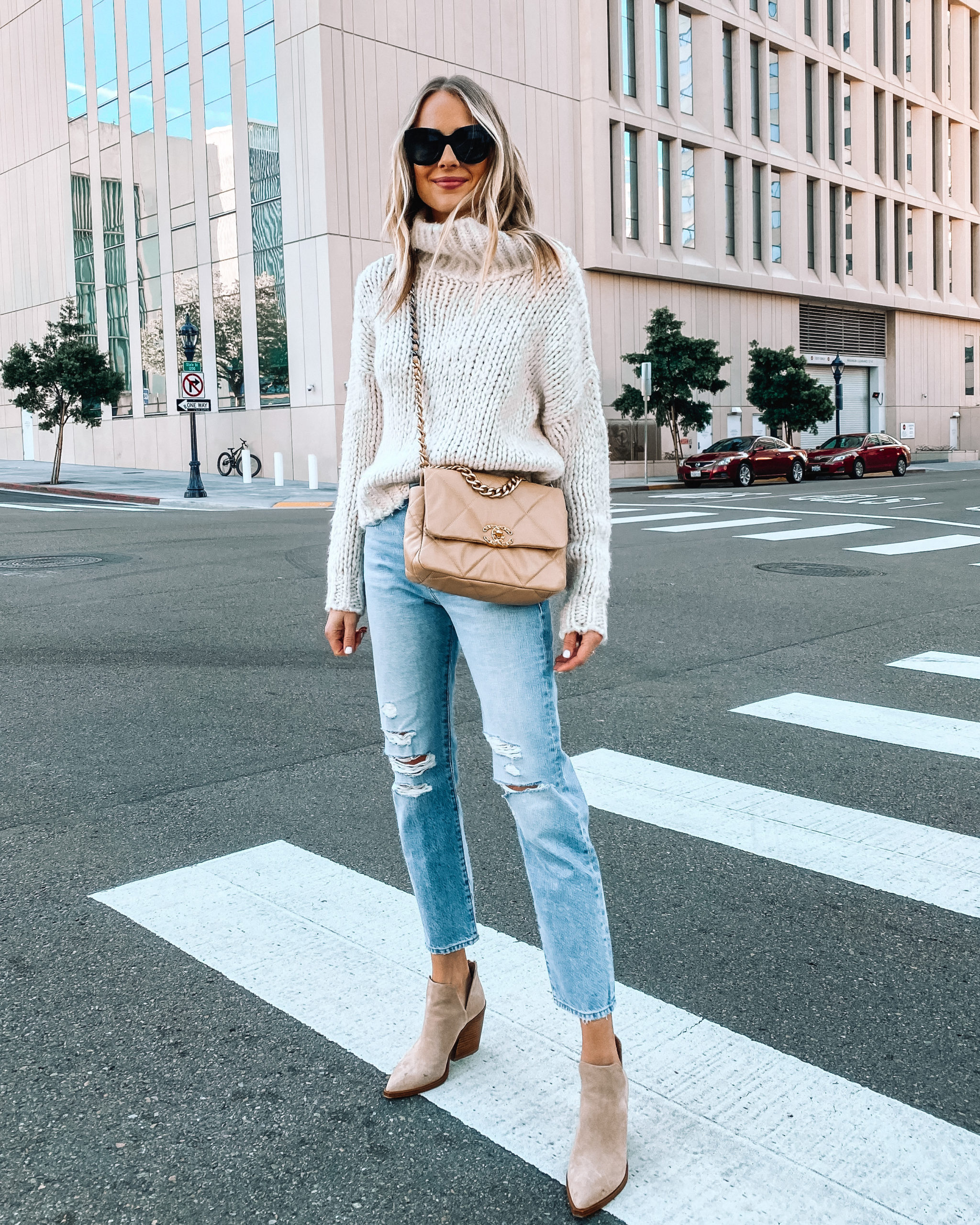 Fashion Jackson Wearing Beige Turtleneck Oversized Knit Sweater Ripped Jeans Tan Booties Chanel 19 Handbag