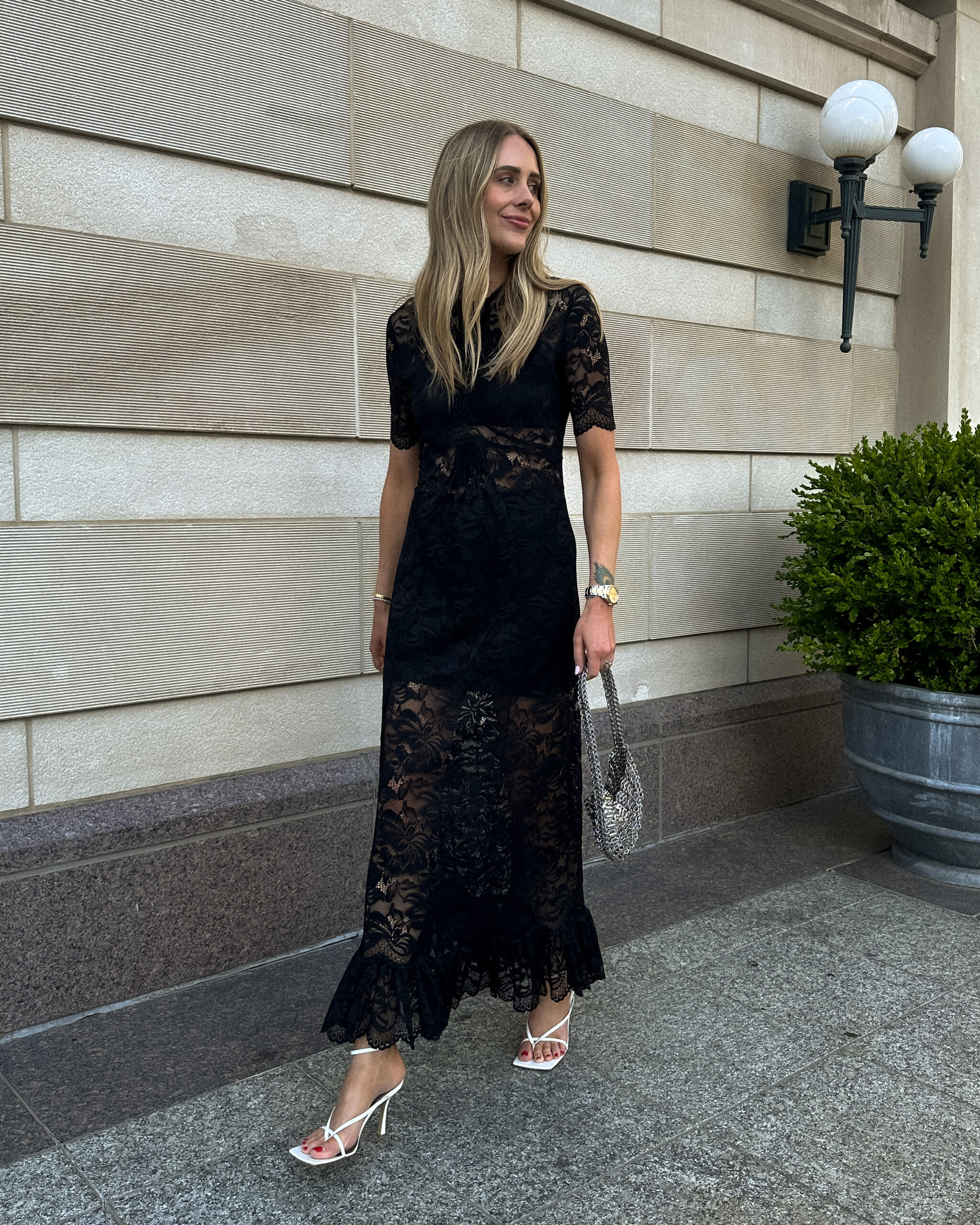 Fashion Jackson wearing Rabanne Black Lace Maxi Dress Bottega Veneta White Strappy Sandals Wedding Guest Dress Outfit