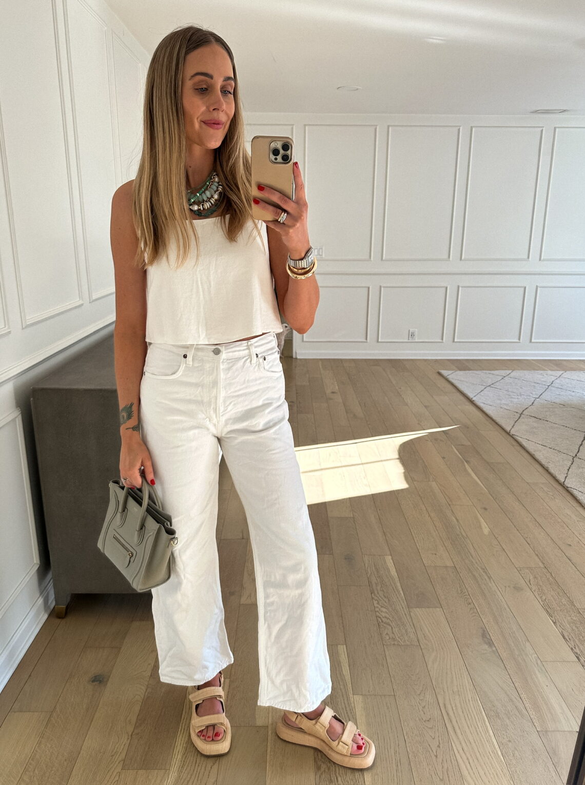 Fashion Jackson Wearing White Tank AGOLDE White Jeans Loeffler Randal Raffia Sandals Celine Mini Luggage Tote Green Necklaces Summer Outfit