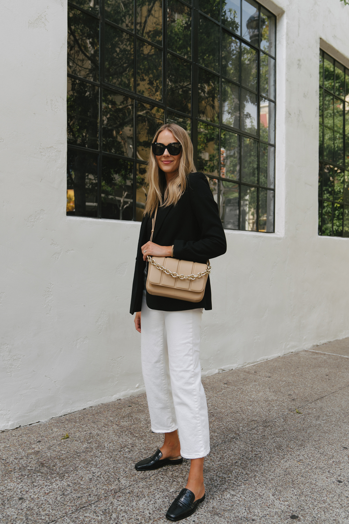 Fashion Jackson Wearing black Blazer White Jeans Black Croc Loafers Beige Crossbody Handbag