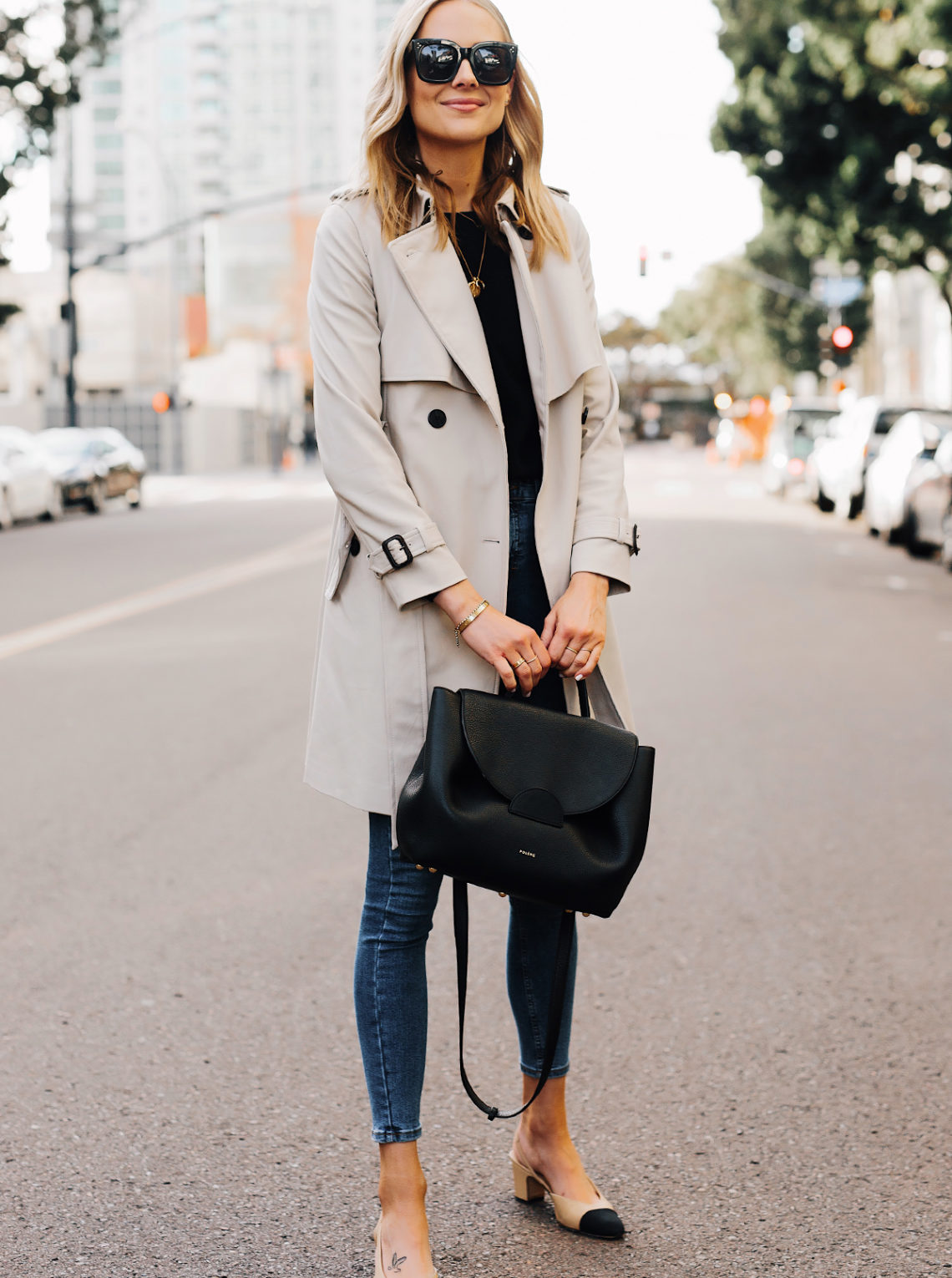 Blonde Woman Wearing Trench Coat Black Sweater Denim Skinny Jeans Chanel Slingbacks Polene Number One Handbag Monochrome Black Fashion Jackson San Diego Fashion Blogger Street Style