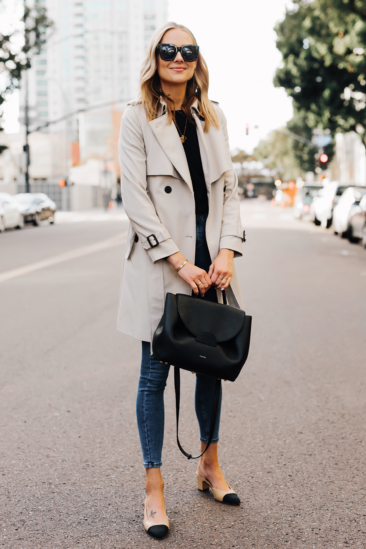 Blonde Woman Wearing Trench Coat Black Sweater Denim Skinny Jeans Chanel Slingbacks Polene Number One Handbag Monochrome Black Fashion Jackson San Diego Fashion Blogger Street Style