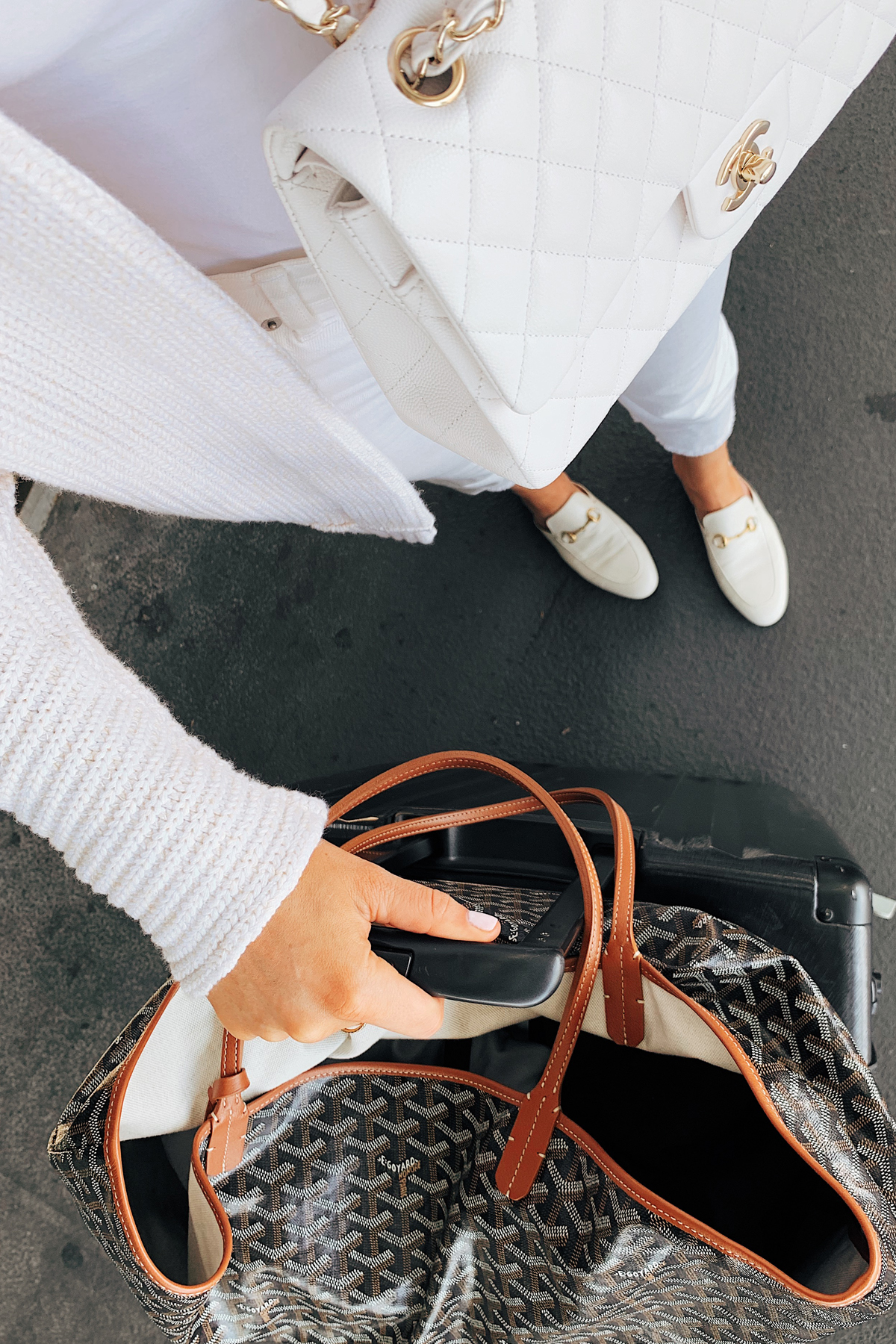 Fashion Jackson Wearing Free People White Tunic Sweater Levis High Rise Jeans White Gucci Muules White Chanel Handbag Calpak Luggage Goyard Tote Airport Outfit Travel Outfit 1