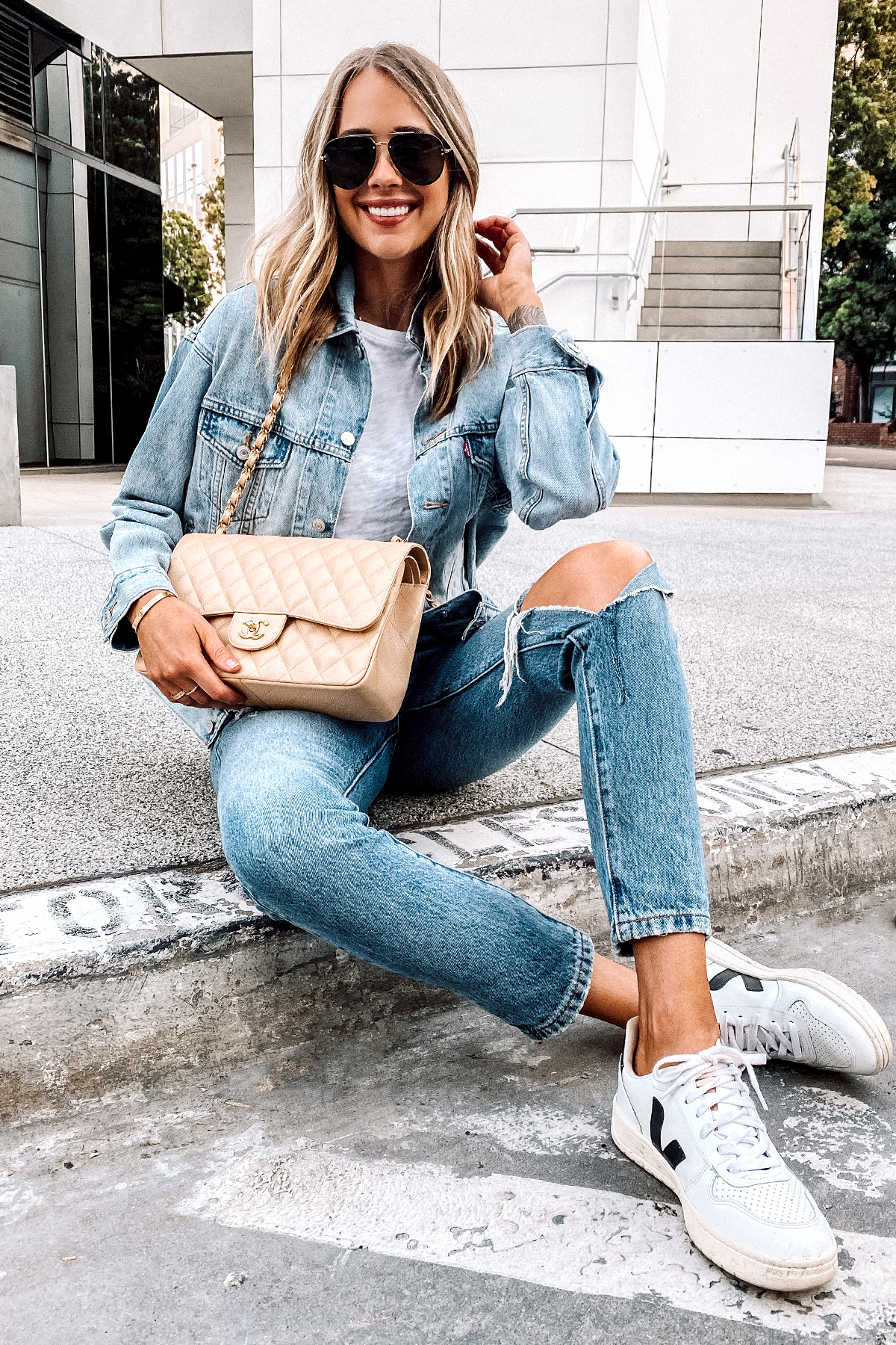 Fashion Jackson Sitting Wearing Levis Dad Trucker Jacket in Dad Michael ATM White Tshirt Levis 501 Ripped Jeans Veja V10 Sneakers Beige Chanel Jumbo Handbag 1